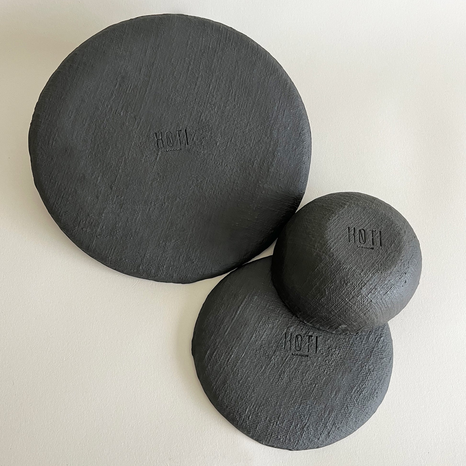 black textured ceramic plates and bowl