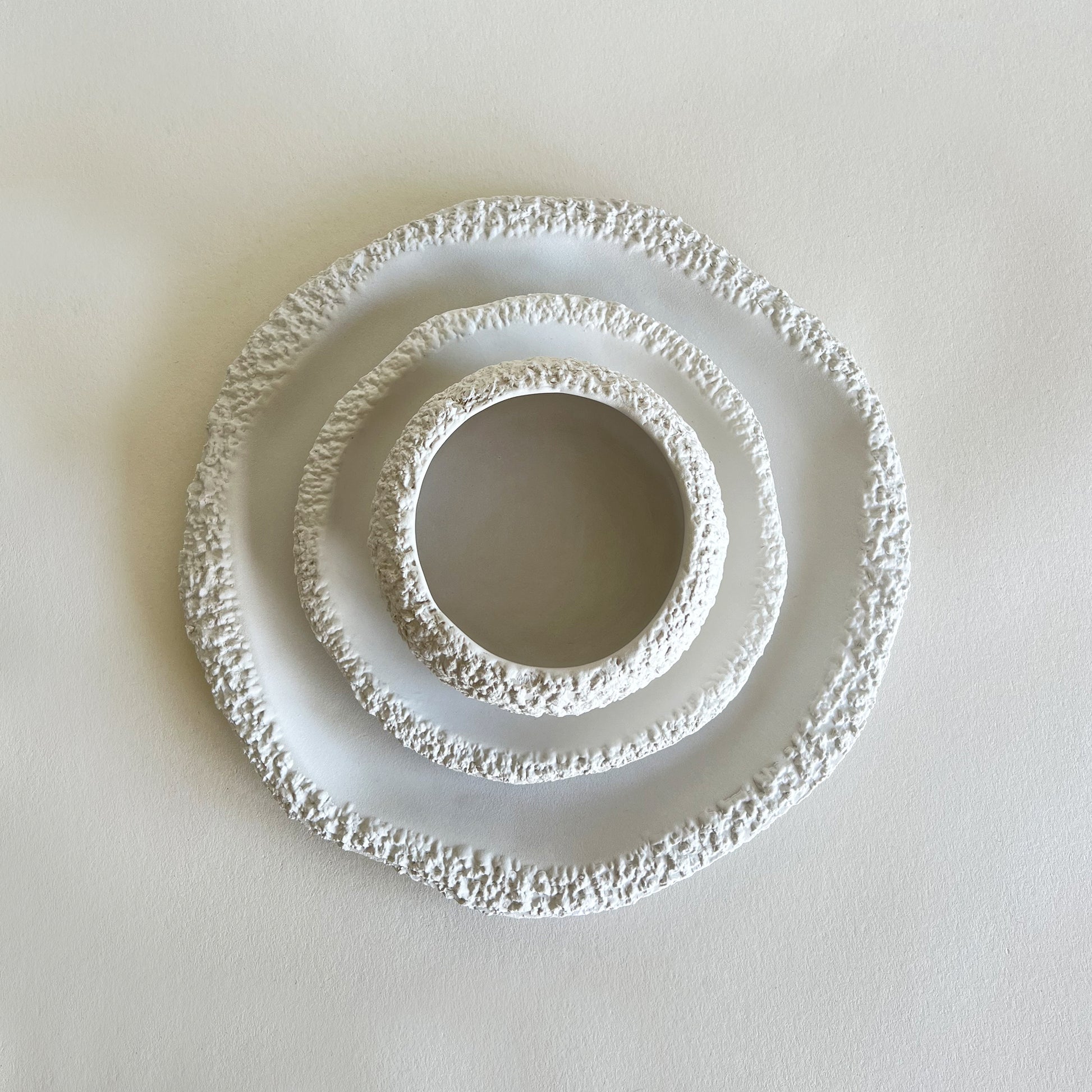 white ceramic set of plates and bowl