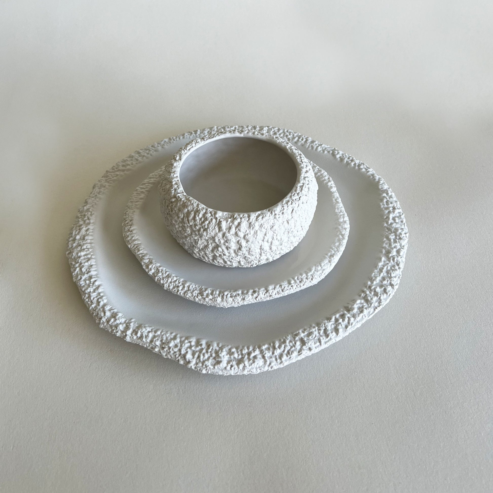 white ceramic plates and bowl