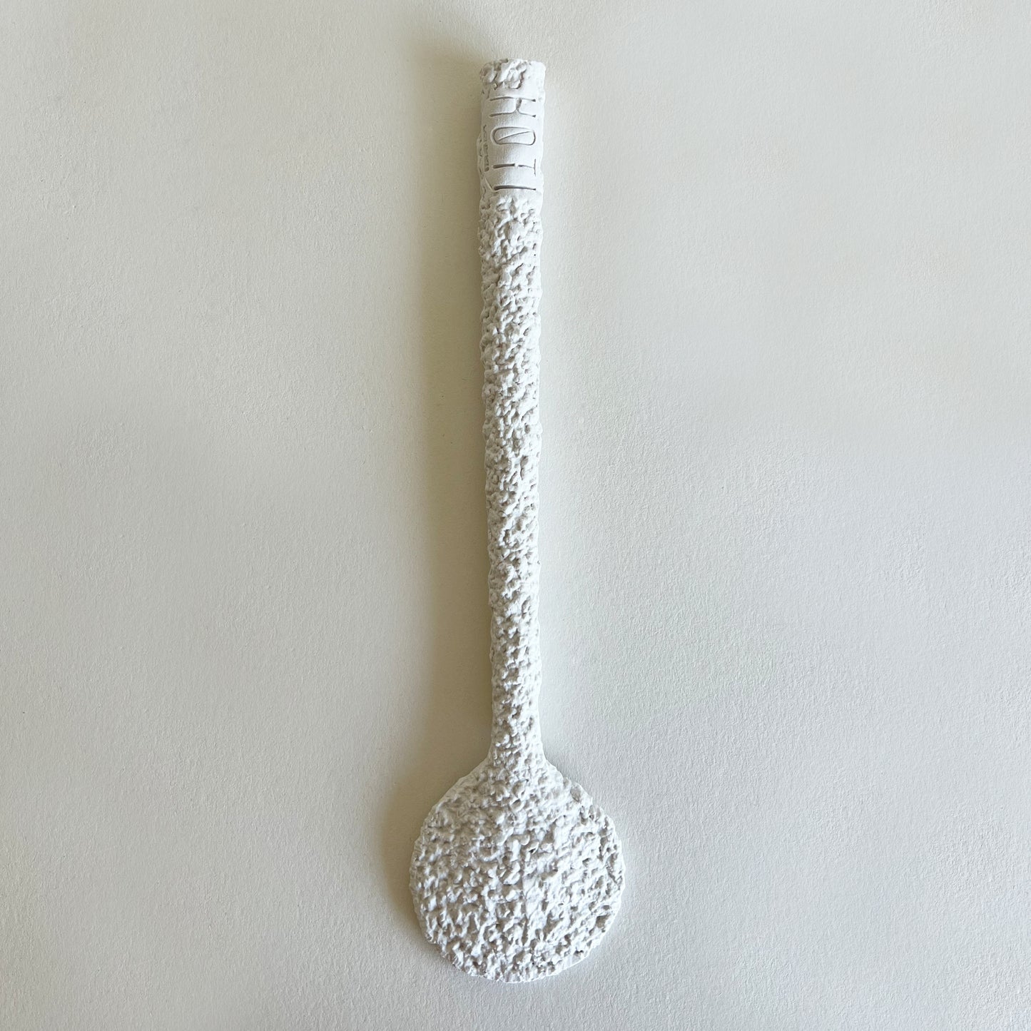 white ceramic serving spoon